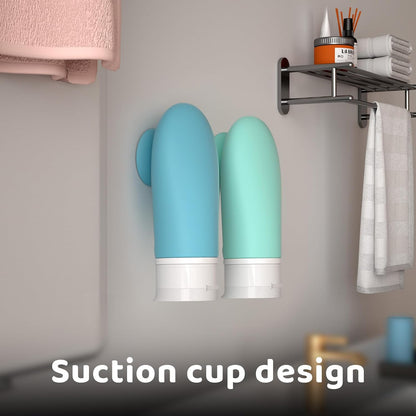 Two blue and green wall-mounted travel bottles with suction cups in a bathroom setting.